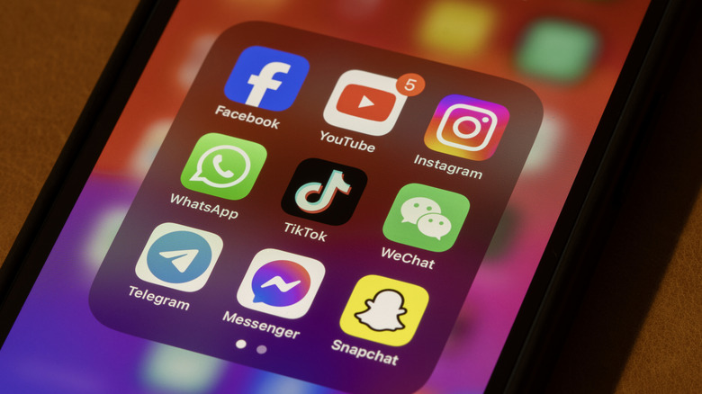 A phone showing a folder of social media apps