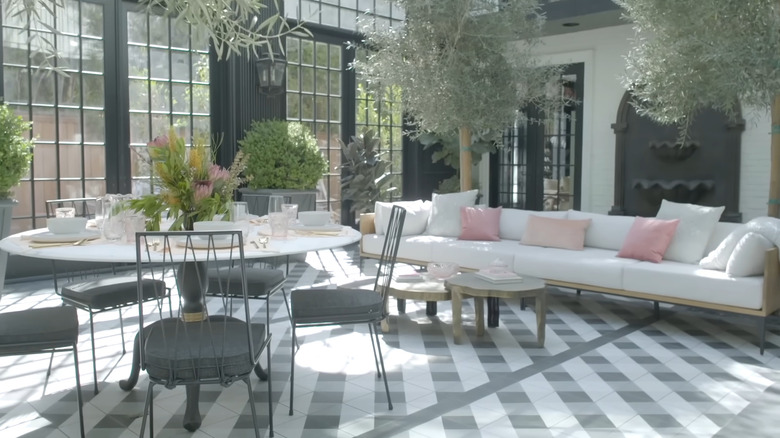 Modern enclosed patio with dining furniture.