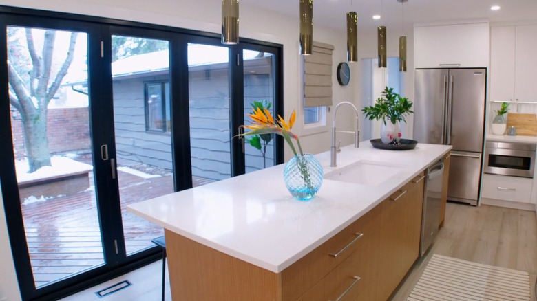 A kitchen with bifold glass doors to the patio