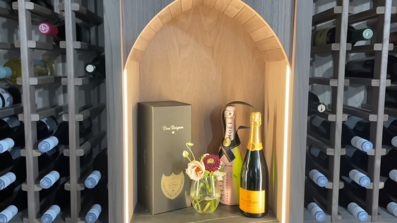 A close up on a wall to wall wine rack.