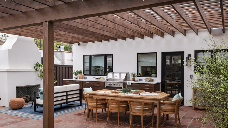 A modern patio with a wooden pergola.