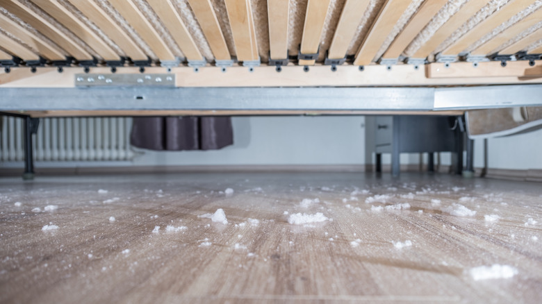 A large collection of dirt and dust under a bed