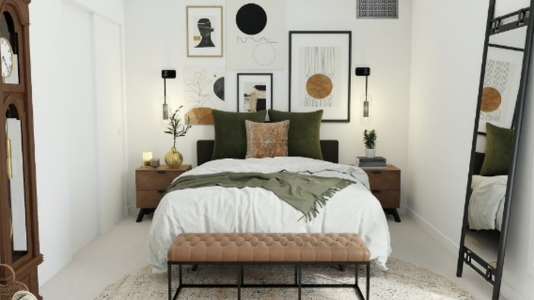 Gallery wall above a bed with vent showing in the upper right corner