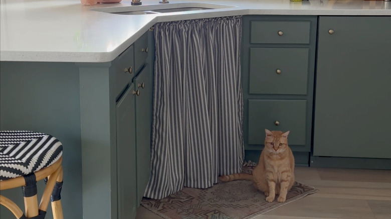 green kitchen with striped curtain