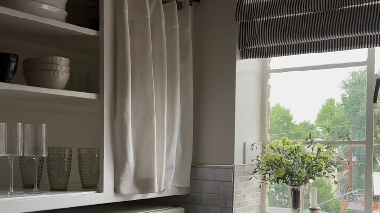 Kitchen cupboards with white curtains
