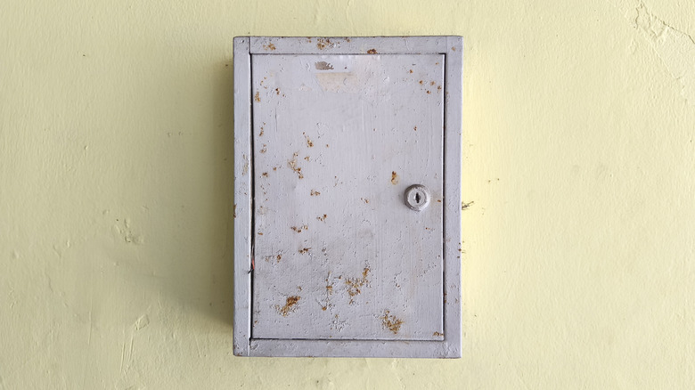 gray electrical box on yellow background
