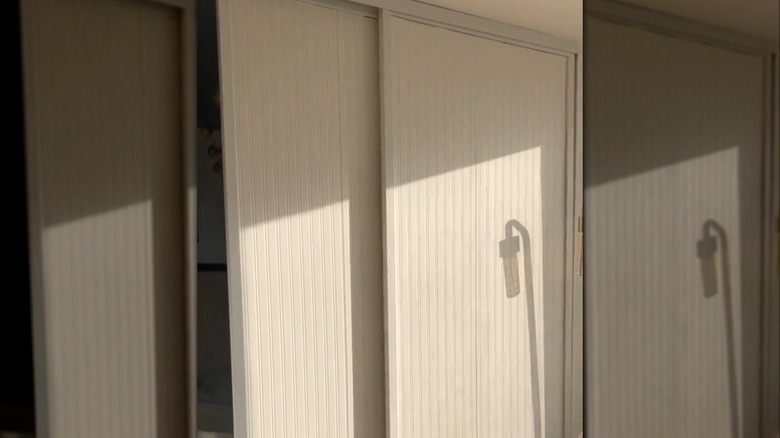 Sliding glass door covered with white paintable wallpaper