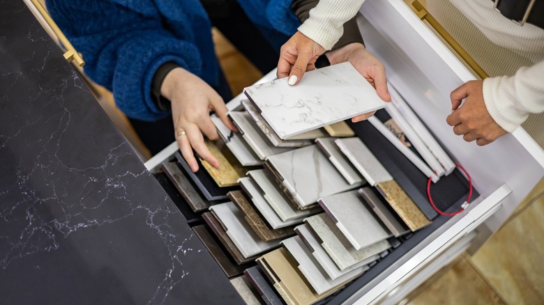 People looking through flooring samples