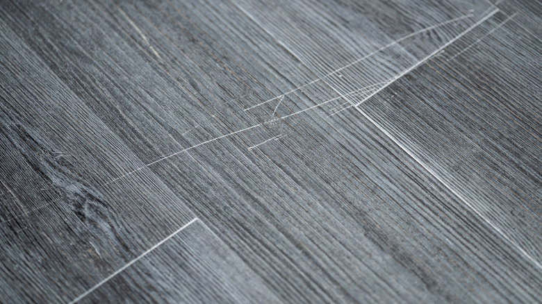 scratches on gray-colored flooring