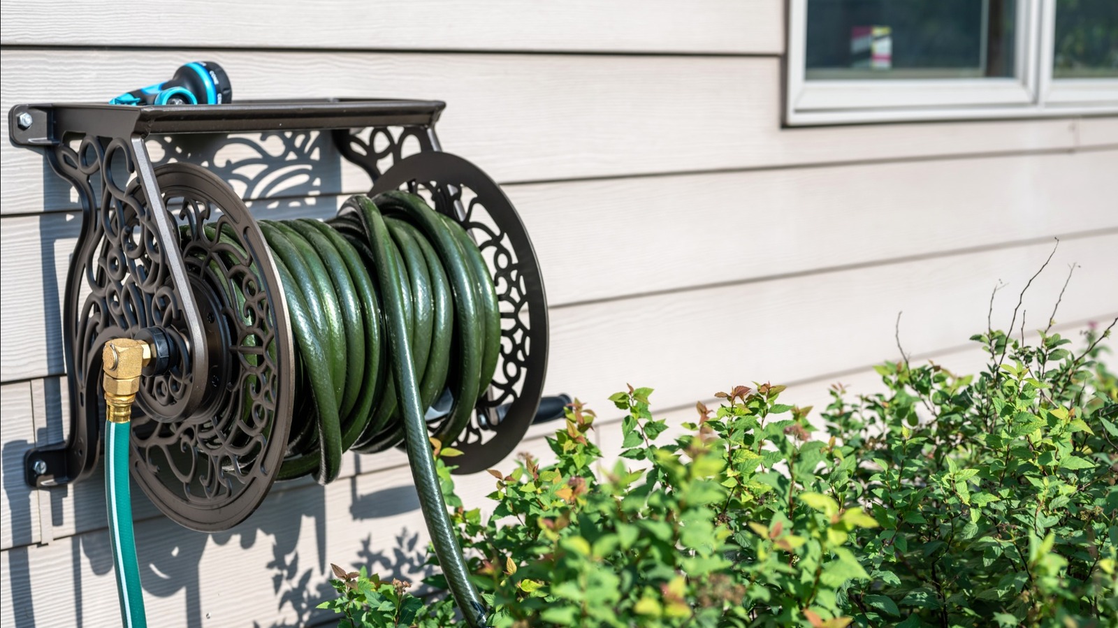 Hide The Eyesore Of An Outdoor Garden Hose With A DIY Storage Solution