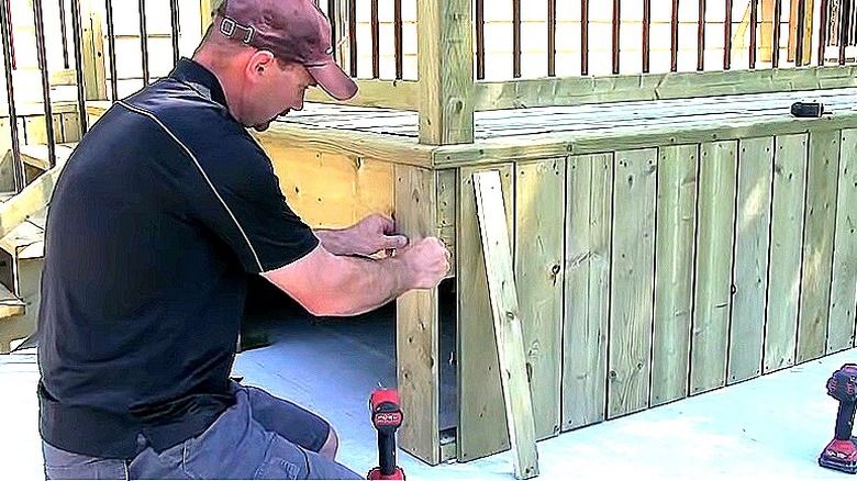 Person adding skirting to deck