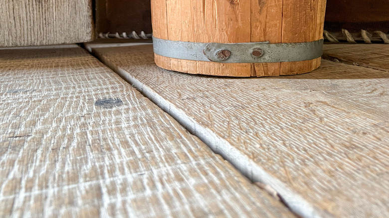 An old oak barrel being used as a trash can.
