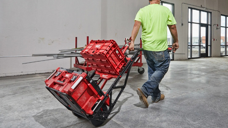 A man pulling a 2-Wheel Utility Cart from Milwaukee