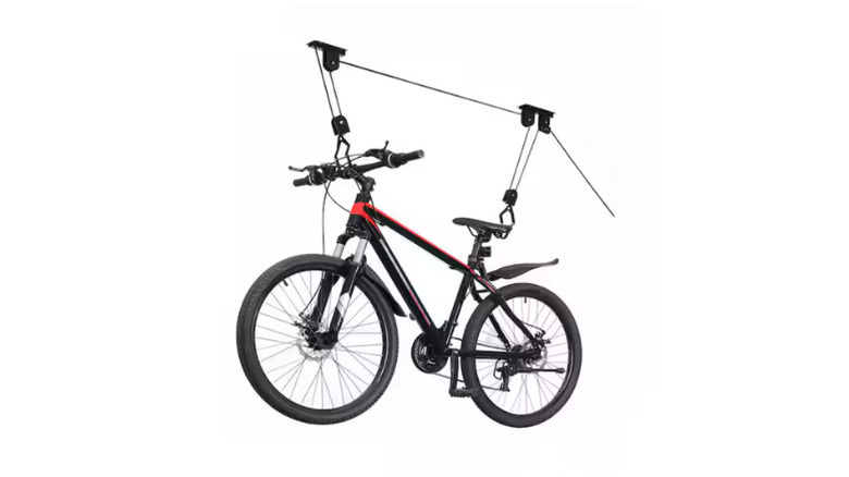 A bike suspended from Robtec's Black 1-Bike Heavy Duty Hoist Garage Bike Rack