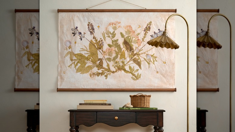 Pressed floral wall tapestry above a hallway side table