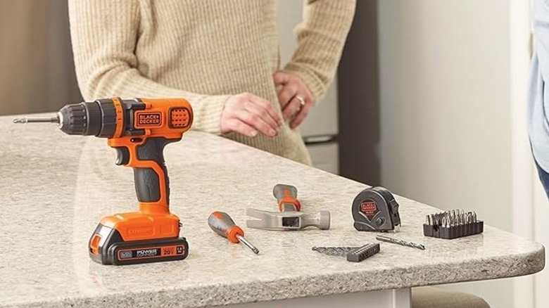 Pieces of the Black+Decker 20V MAX Cordless Drill and Home Tool Kit on kitchen counter