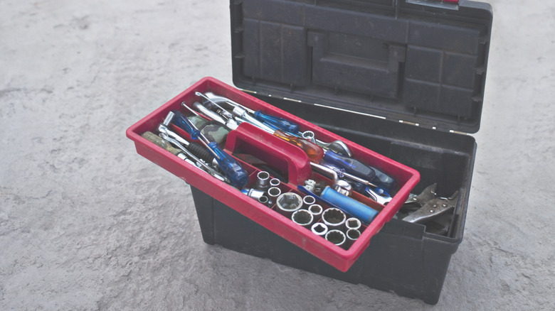 Full, open tool box on floor