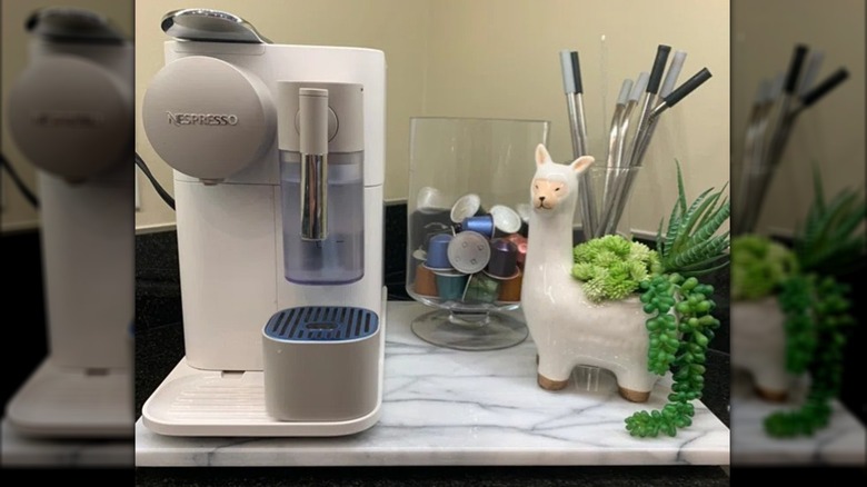 Marble pastry board set below alcohol, cranberries, and decorative elf on wood table