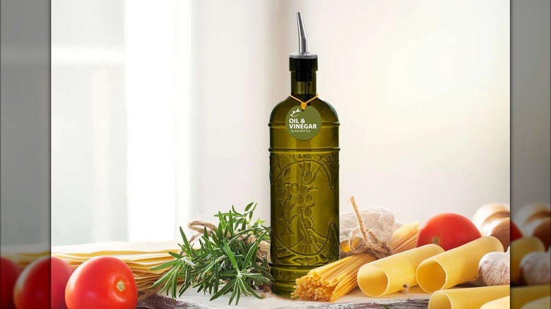Oil and vinegar olive green cruet among staged kitchen ingredients