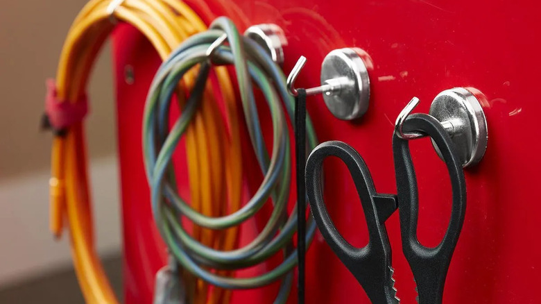 Various items hang on magnetic hooks.