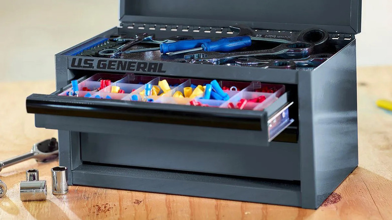 A mini toolbox sits on a table.