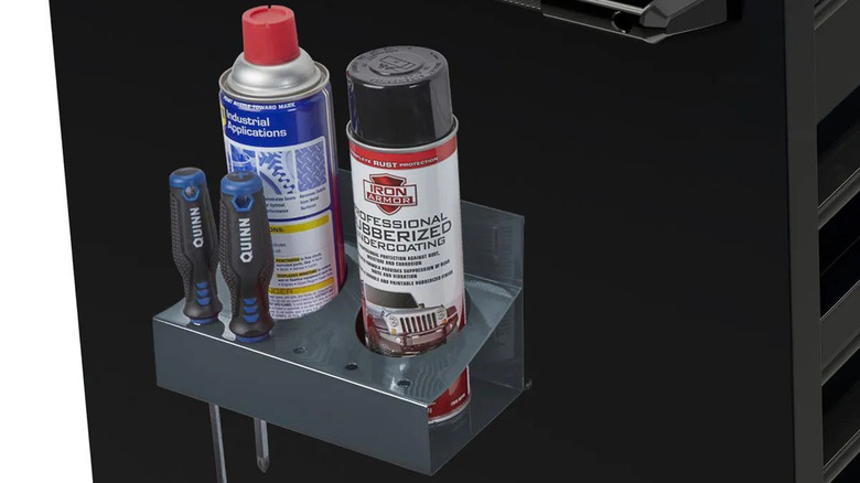 A spray can holder holds two aerosol cans and screwdrivers.