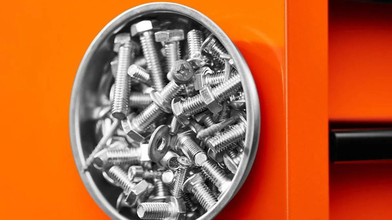 A magnetic dish holds bolts and washers.
