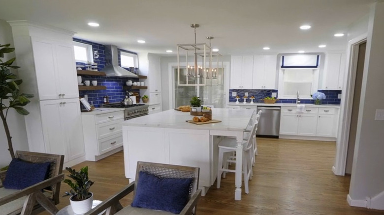 Large modern kitchen with a blue backsplash.