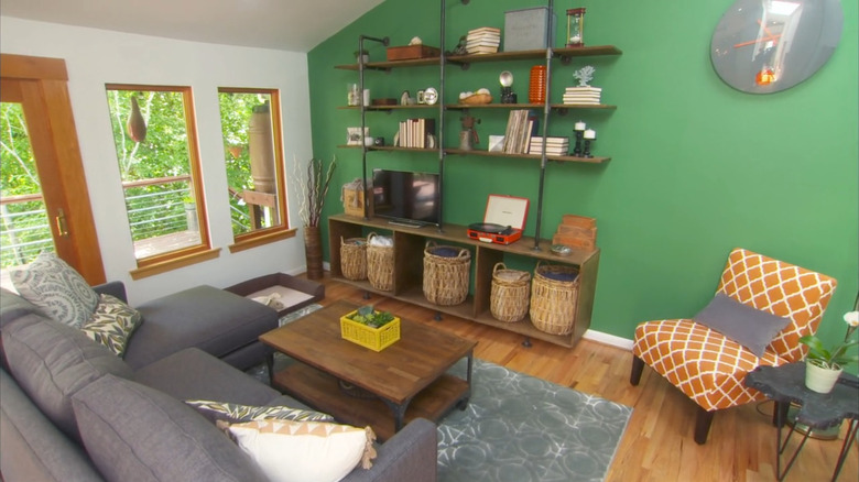 Bright green accent wall in living room.