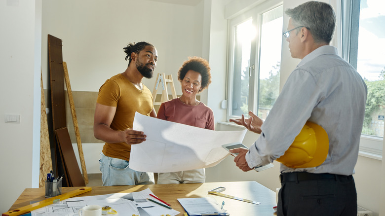Couple talking to home contractor