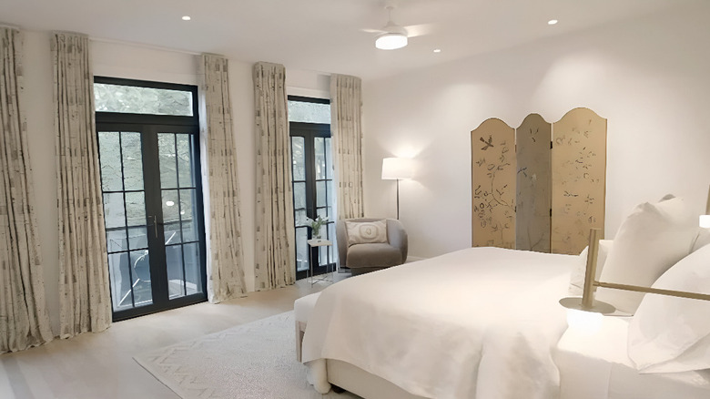 decorative antique screen against wall in bedroom
