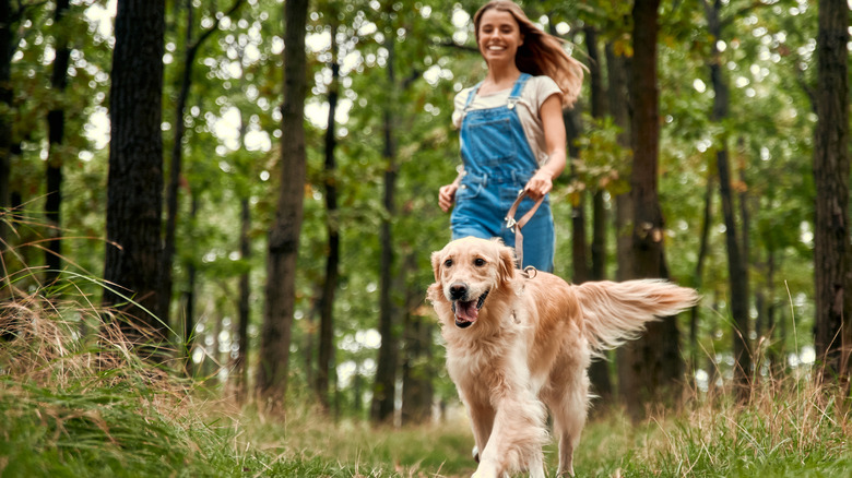 woman running with golden retriever