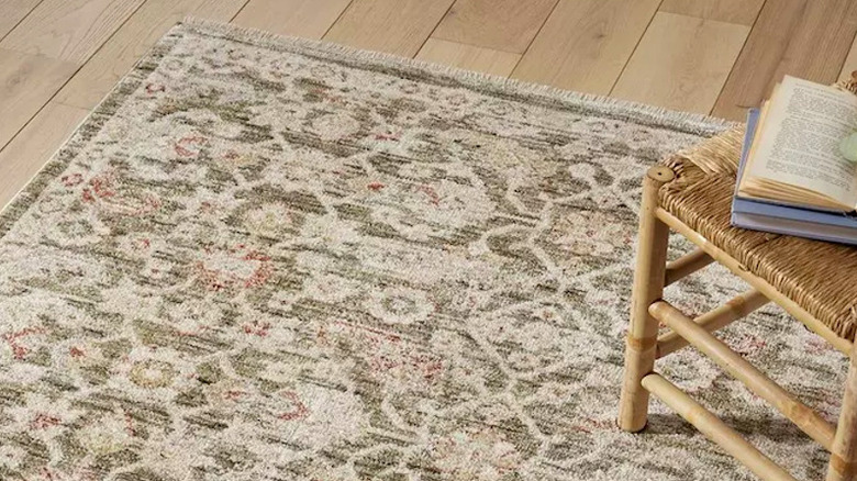 A patterned rug on a lightly colored wooden floor