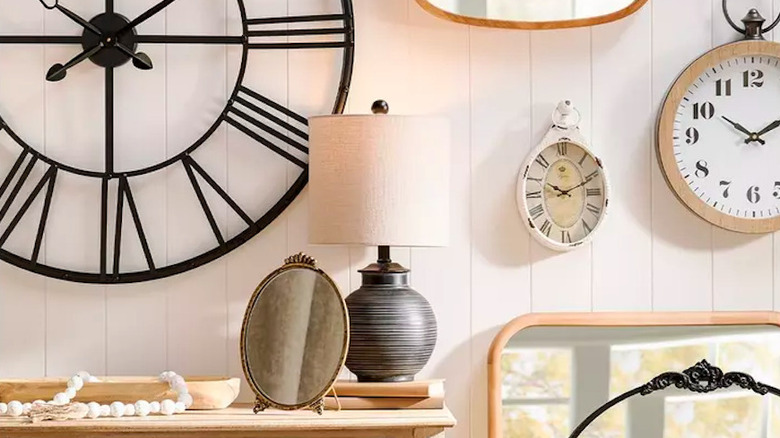 Hobby Lobby lamp with a selection of clocks and other decor displayed