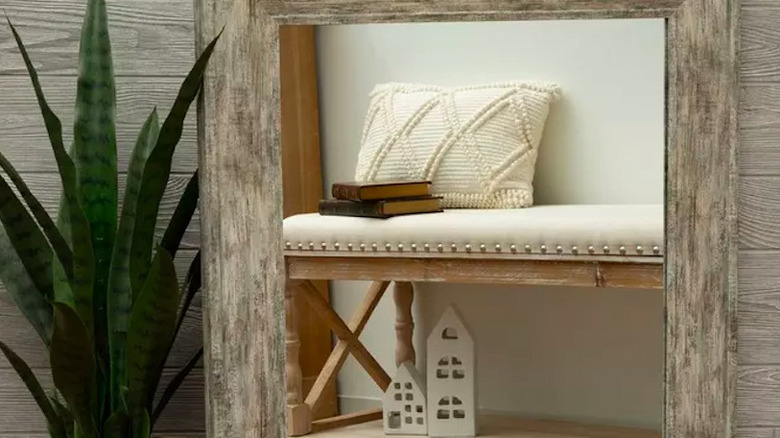 A wooden rectangular mirror