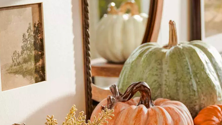 A canvas surrounded by pumpkins