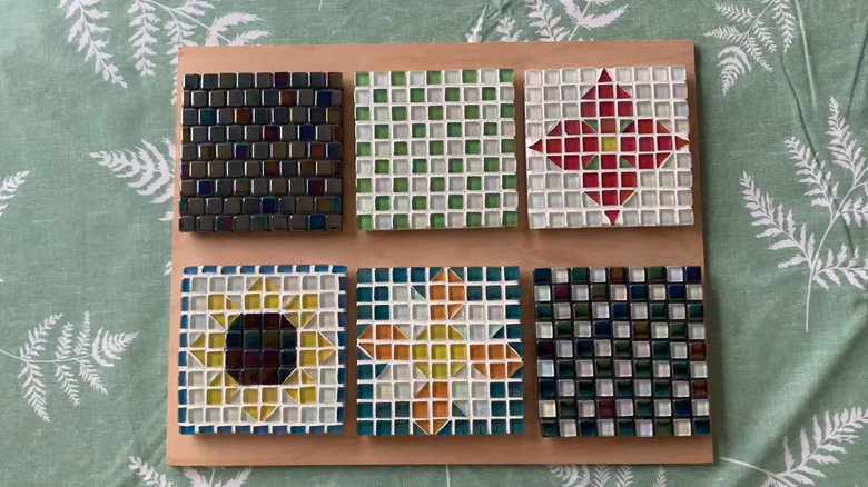 Six patterned mosaic tile coasters, some checkered, others floral.