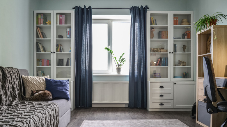 room with dark blue curtains