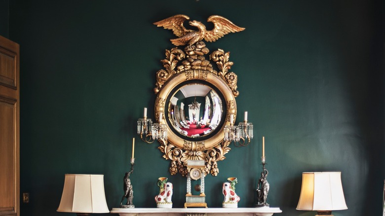 elaborate bronze mirror on wall