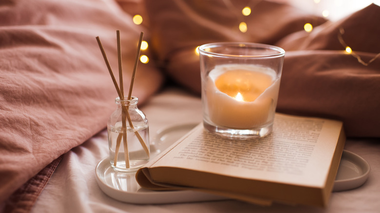 lit candle on book