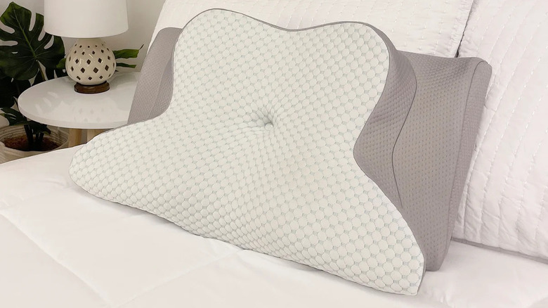A Dream Plush Memory Foam Side Sleeper Pillow on a bed