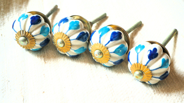 A row of vintage drawer pulls knobs