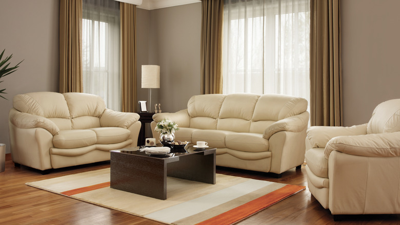 A living room with a matching couch set