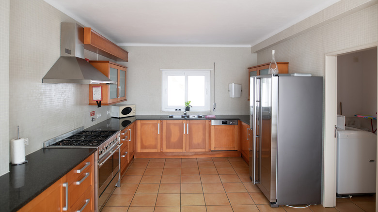 Outdated kitchen with orange-toned cabinets