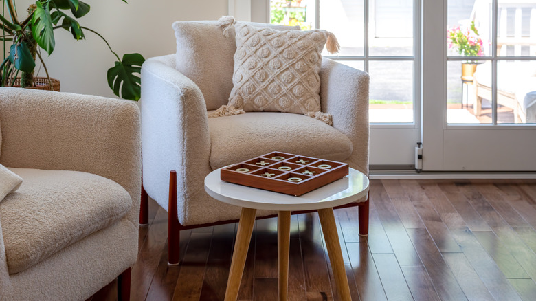 White boucle chairs next to a small table