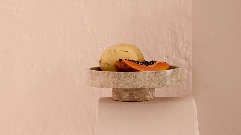 beige marble bowl with fruit in it