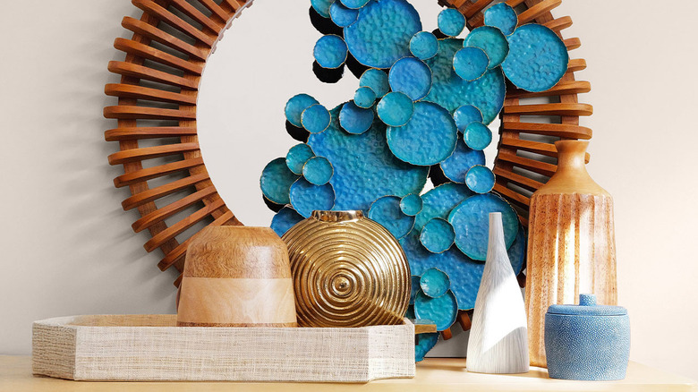 Gold, wooden, and stone home decor trinkets in a vignette