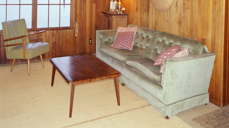 Walls in this 1950s living room are clad in wood paneling.