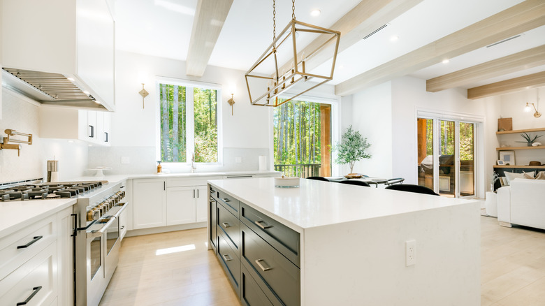 A large light fixture hanging over kitchen island