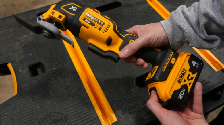 Hand holding a DeWalt Lithium-Ion Cordless 3-Tool